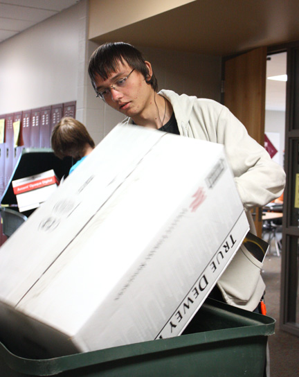 Michael Haynes, 12, collects recyclables  on Sept, 9 to be sent to International papers.  Recycling Club collected more than five tons last year. Photo by E. Steenbock