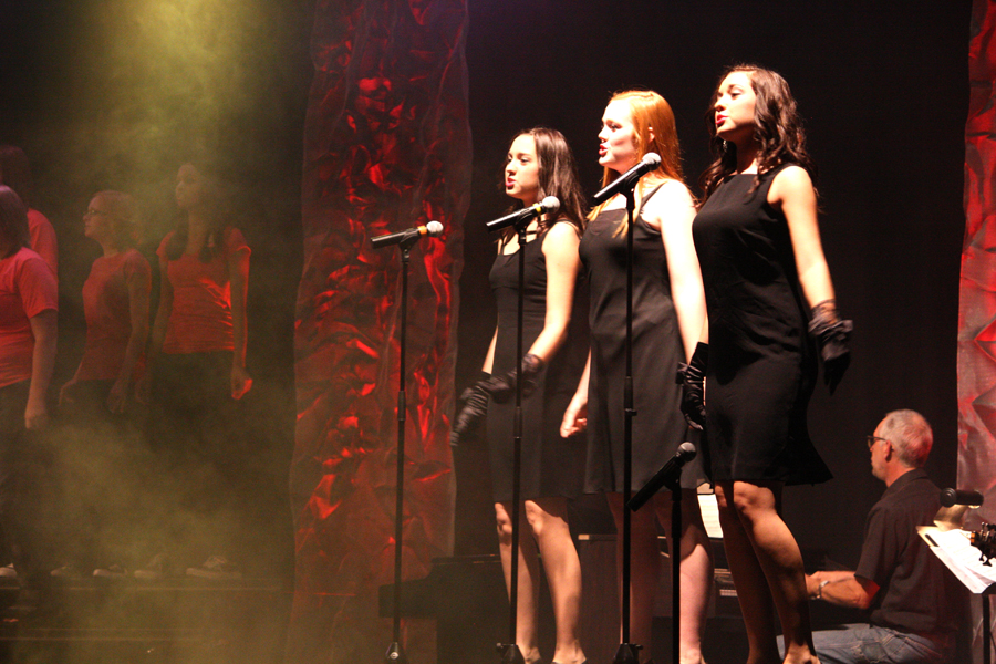 Meghan Munday, Gabby Weins and Morgan Munday, all 10, sing a feature at the concert on Oct. 15. Photo by J. Hilgers