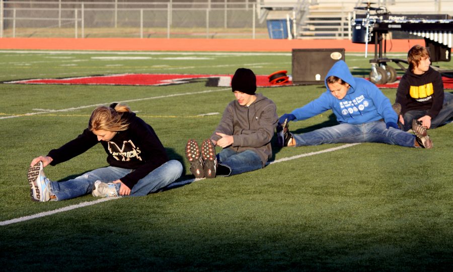 Students stretch before marching band practice. They performed numbers from the Cirque du soleil – La Nouba show and received a superior rating. Photo by L. Schumaker