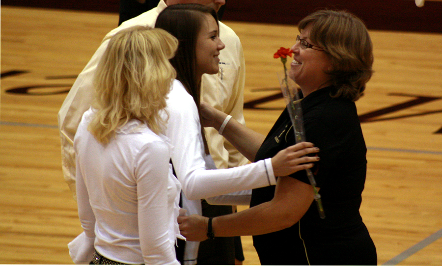 On Oct. 19 Teri Larson, coach, hugs Mackenzie Obermeyer, 12, during senior night.  Larson congratulated Obermeyer on a well done season. Photo by M. Loomis           