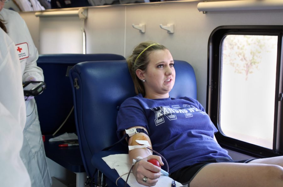 Trying to keep calm while giving blood, Natalie Demoure, 11, cringes. Demoure decided to give blood as a way to give back to the community. Photo by E. Steenbock
