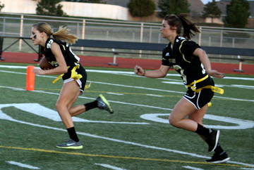 Hannah Grubbs, 12, runs down the field after taking the football. She later would score a touchdown. Photo by A. Esser