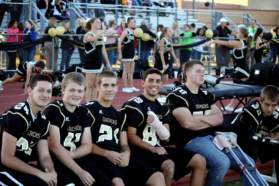 Football players from left Britton Farney, 11, Alex McGuire, 10, David Northrup, 12, Danny Minks, 12, Dylan Amspacker, 12, and Jacob Lankutis, 10, sit on the bench during the Sept. 30 homecoming game. Taking up the whole bench these team members were unable to play due to their various injuries. Photo by A. Esser