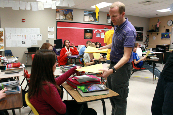 Blake Smith, science, collects homework from students for Freshman General Science on Jan 17. Smith was awarded Kansas Horizon Award for being an outstanding first-year teacher. Photo by G. Buckner