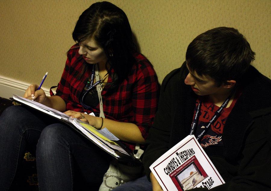 Andrew Horning helps Kayla McLaughlin, both 12, prepare for her scholarship monologue. McLaughlin performed a piece derived from the novel She Said Yes by Misty Bernall. Photo by C. Butcher