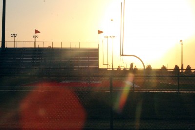 The sun illuminates K.T. Woodman stadium on Tuesday evening. Photo by Kalee Betzen.