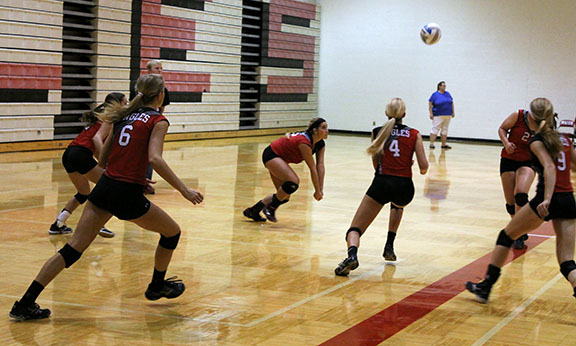 Senior Maddi Cumpston sets the ball while playing against Rose Hill. Photo by Jet *
