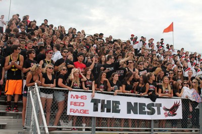 The student section rallies the football team after pregame Friday night at home against Salina South. Photo by Brooke Johanson.