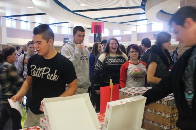Seniors receive juice and donuts during the senior celebratory farewell ceremony today in the commons.