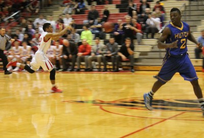 Junior Ky-Sean Johnson throws a pass to a teammate while running down the court during Friday night's game against Hutch.