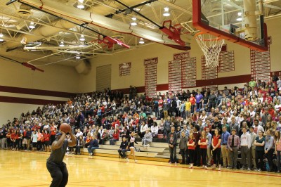 Senior Nick Benford competes against teachers in a blindfolded free throw competition during today's pep assembly. 