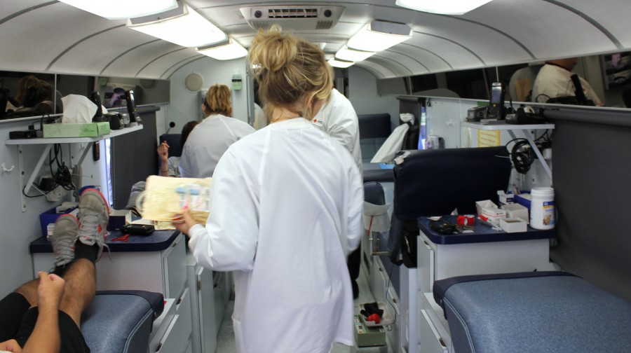Nurse prepares to collect blood during a blood drive in January 2013.