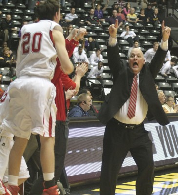Coach Chris Davis celebrates Thursday's victory that puts Maize in the state semifinals. Photo by Hallie Bontrager.