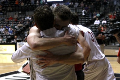 Aaron Shaw embraces principal Chris Botts after defeated Olathe East in the state quarterfinals Thursday at Koch Arena. Photo by Hallie Bontrager