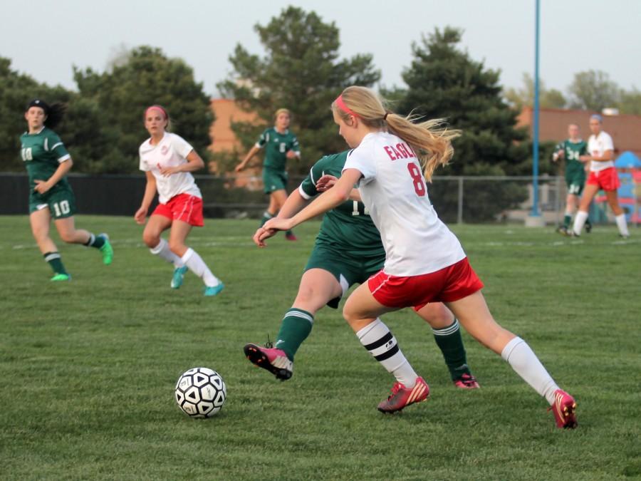 Senior Becca Andrus, 8, tries to move past Salina South defense. Photo by Katie McLachlan.