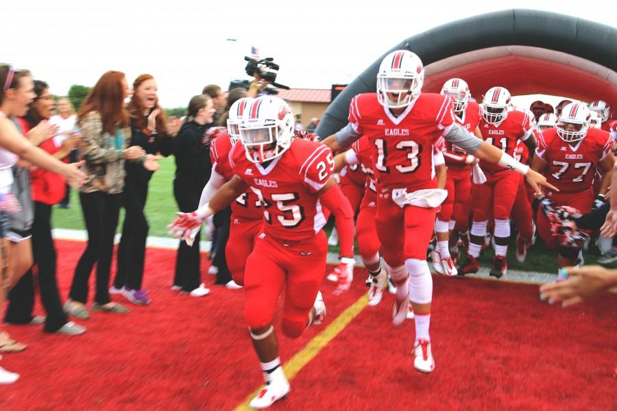 Seniors Elija West and Connor Lungwits run from the tunnel before their game against Derby Sept. 5.