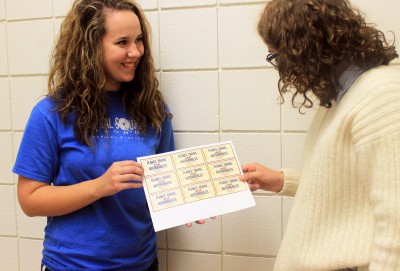Junior Tatum Nevins, shows Junior Sandra Carlo tickets to the choir concert which will be held on Sept. 26 and 27.