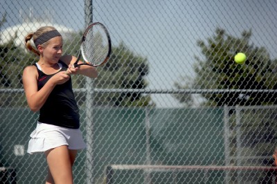 Kendra Cunningham hits a backhand during her doubles match.