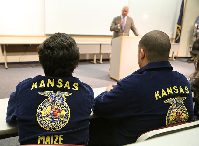 FFA president Stylan Roberts and member Cody VanDeusen listen to a speaker talk at a conference hosted in the Lecture Hall.