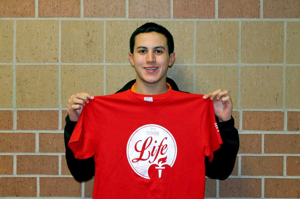Sophomore Ryan Kuhl  models the shirt that will be used for the "red out" on December 5th. 