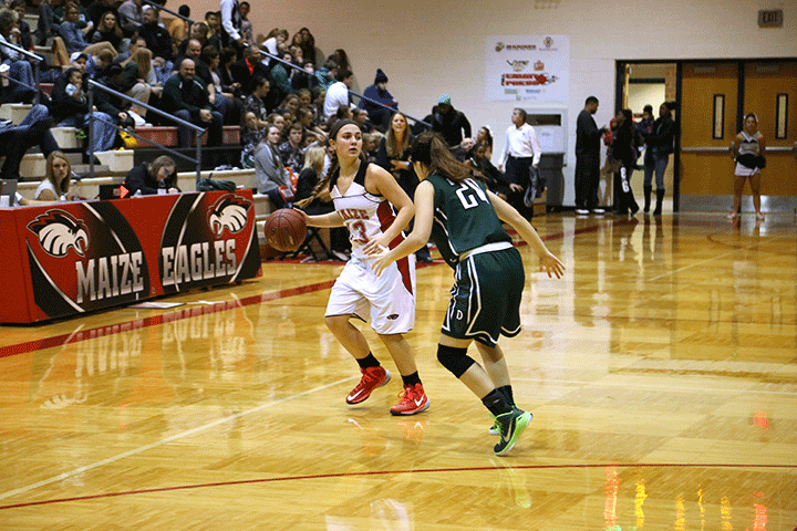 Junior HaLee Roland looks for a teammate to pass to during the Derby game on Tuesday Dec. 16.