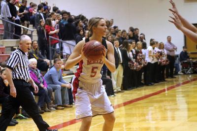Senior Keiryn Swenson looks for a teammate to pass to against Newton, Friday February 28. Swenson led the team in scoring with 20 points. 
