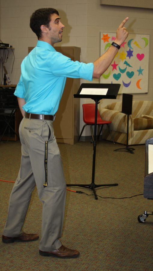 Aaron Weatherbie, Choir Director, conducts the Women's choir in preparation for their fall show. Photo by K. Brown