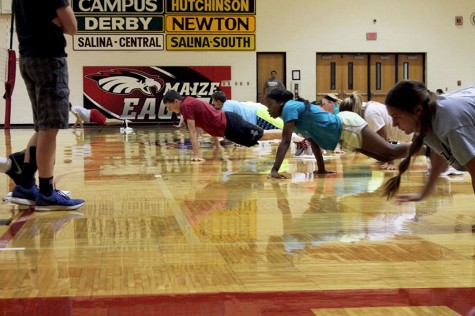 Freshman PE, advanced PE, Cross Fit and Weights classes all participate in "workout Wednesday."  Their workout consists of dragging themselves across the gym while their feet rest on towels.
