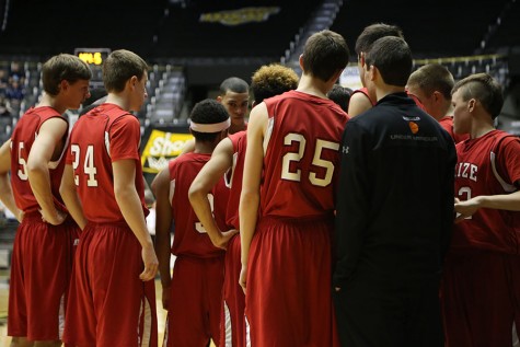 The boys team huddles up during the state tournament last year. The team was eliminated in the first game of the tournament. 