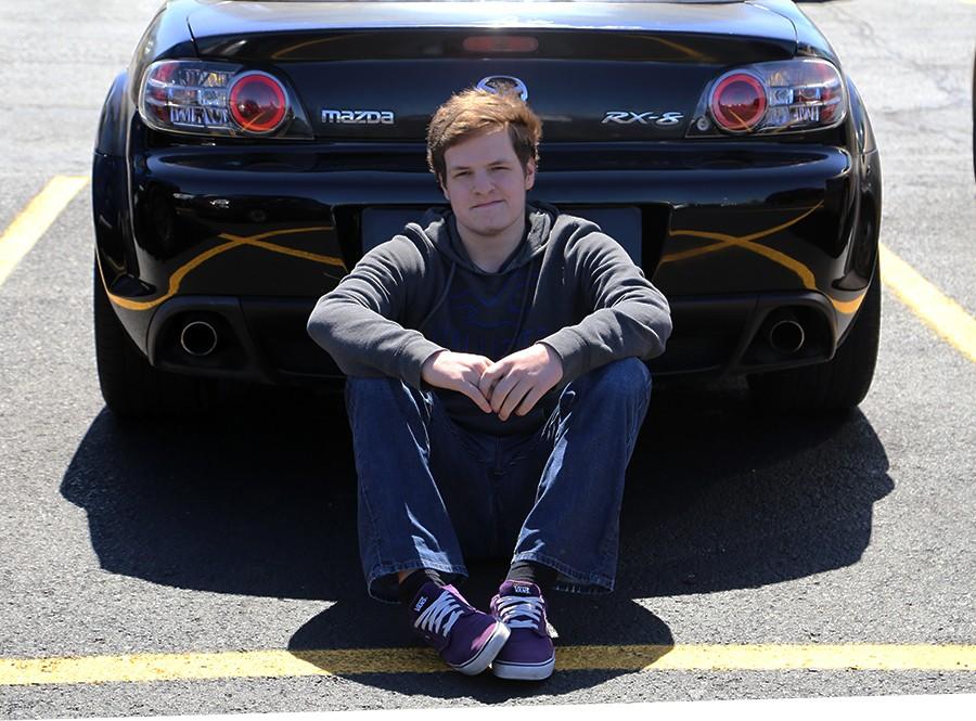 Junior Joshua Frerman sits in front of a friends Mazda RX-8. Photo by Lily McClaren