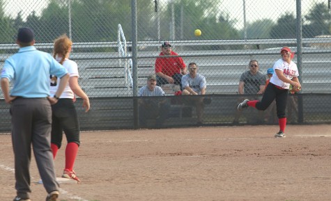 Senior Allie Jergensen throws the ball to sophomore Savannah Hughes between innings. 