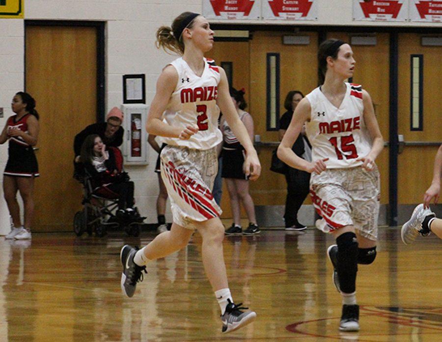 Senior Brecken Roe and sophomore Alexis Cauthon run down court. The Eagles defeated Derby 54-42.