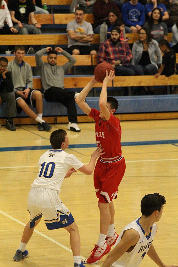 Sophomore Caleb Grill jumps to shoot the ball for Maize against Salina South. 