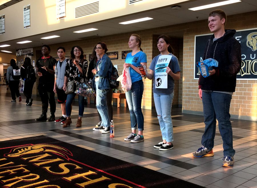 Feminist club passes out candy to the students and staff entering the building to celebrate International Women's Day. Photo by S. Doyle