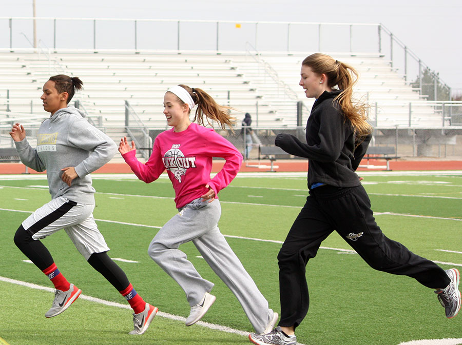 Samantha Bally, 11, Haley Jacques and Courtney Vought, both 10, running sprints during track practice. “Normally if we go outside I like to make sure I have extra layers, even if I am going to take them off,” Bally said. Photo by K. Cabera