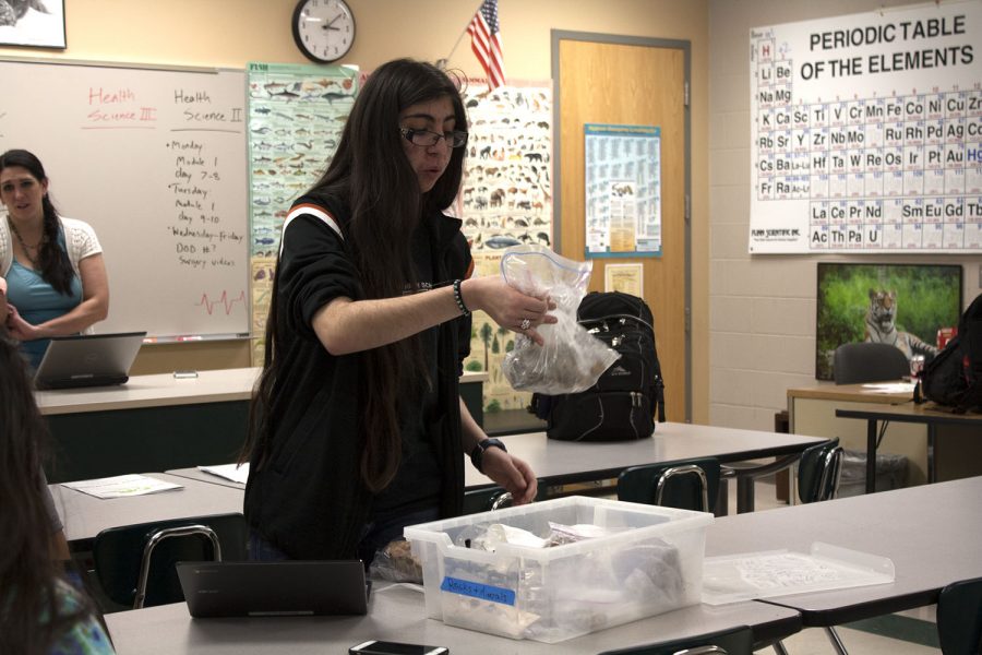 Kimiya Monfared, 11,organizes her box for the Science Olympiad competition. Photo by K. Dunham
