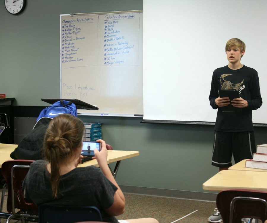 Nate Moore, 9, practices his informative speech in forensics while another classmate records it for critiques. Photo by K. Duhnam