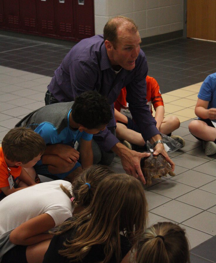 Rob Archibald, science, explains the features of his turtle to a second grade class. Photo by K. Angle
