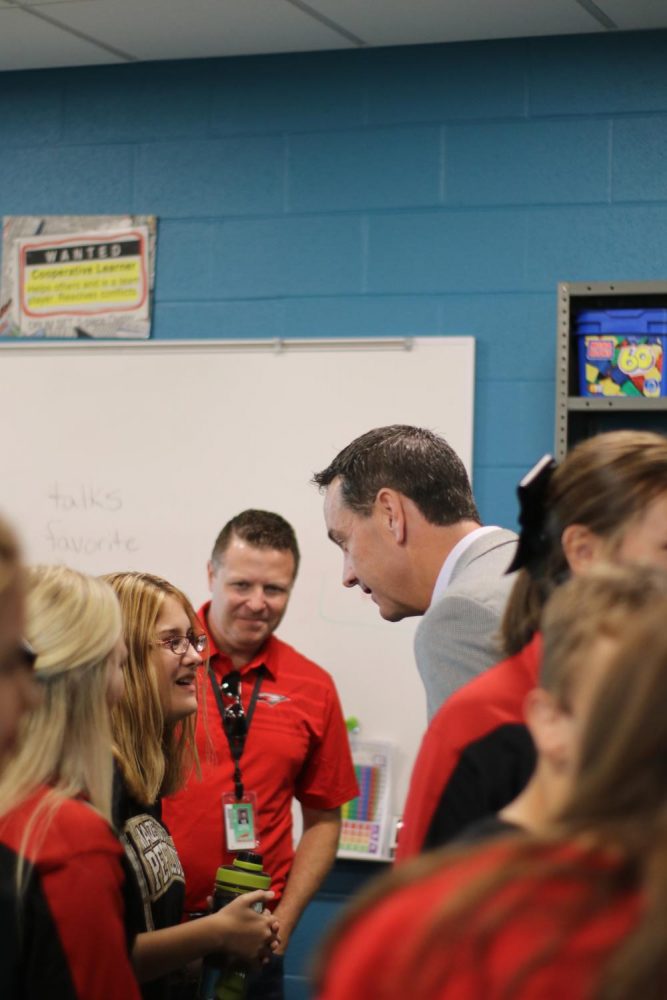 Superintendent Chad Higgins and principal Chris Botts have a conversation with sophmore Alyssa Ramirez. They also attended the friendship club reunion at Maize South.