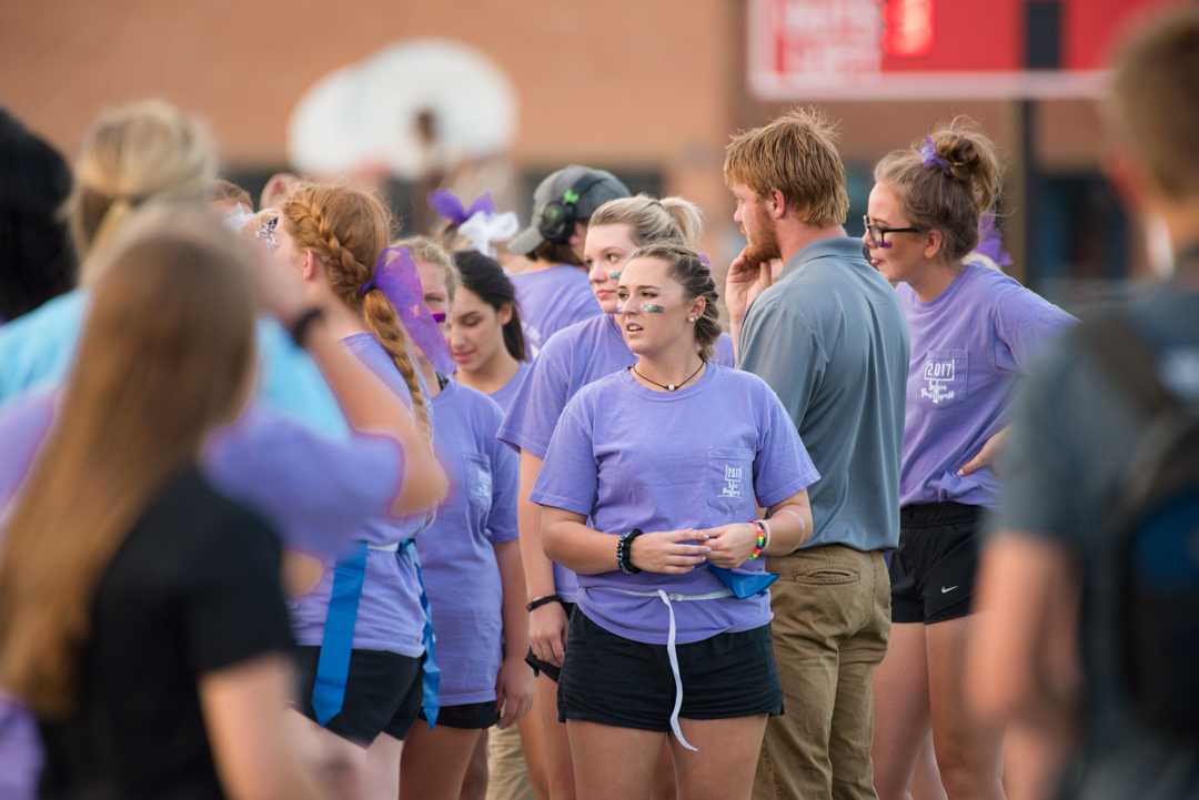Senior Lauryn Ogden stands on the sideline while the coaches are directing the plays. This year the junior class reigned over the seniors and took the win.