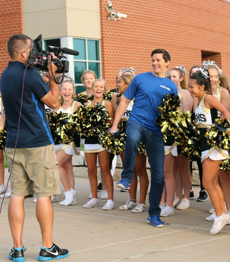 Shane Konicki, KWCH Report and Tiffany Pham,9, begin the cheer for KWCH live coverage. KWCH picked Souths first home game against McPherson to be KWCH high school game of the week. Photo by O. Blanford