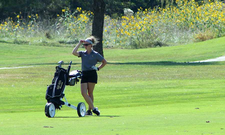 Sarah Hyatt, 12, scouts her next shot. Hyatt participated in the varsity golf tournament on Sept. 14. Photo by K. Baker