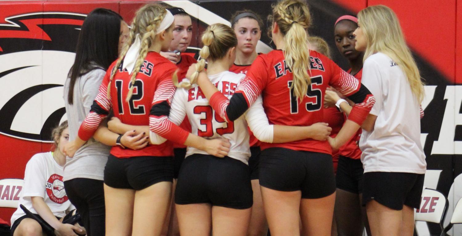 The volleyball team huddles before playing Kapaun. The girls placed third at the tournament. 