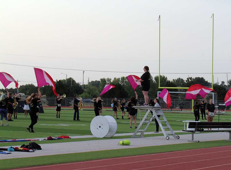 Color Guard practices their routine before the first home game on Sept. 8. Color Guard performs during half time. Photo by O. Blanford