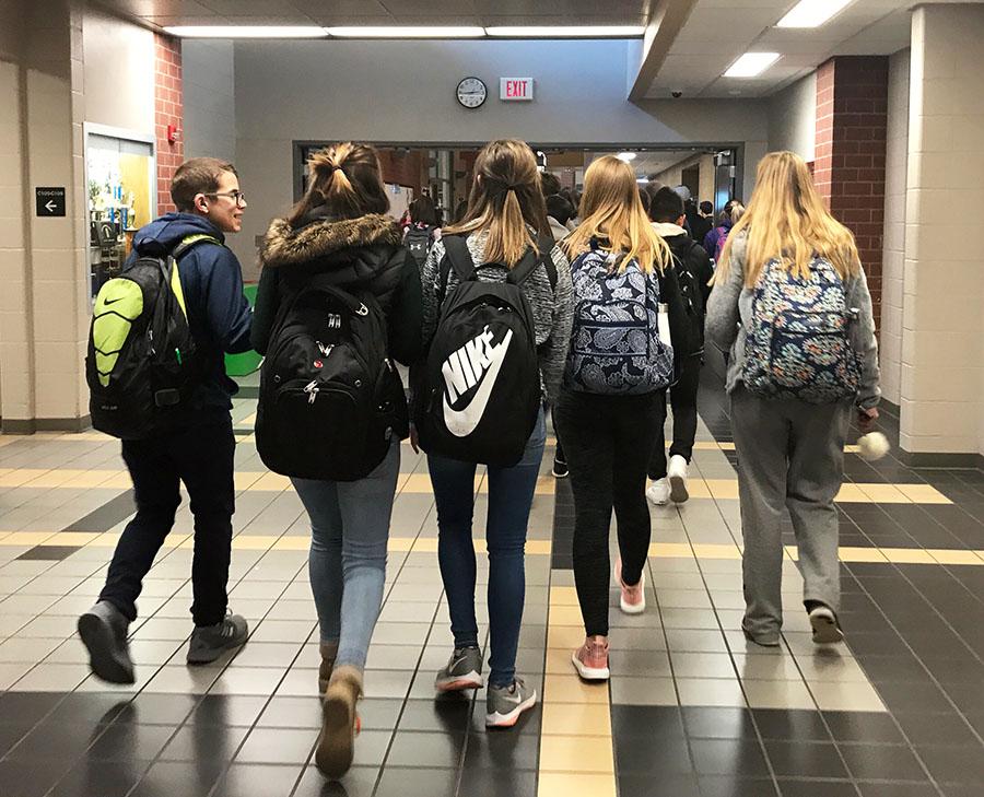 A group of students headed towards the front of the building after the final bell. Students each carrying their backpacks and other personal items. Photo by N. Bliss