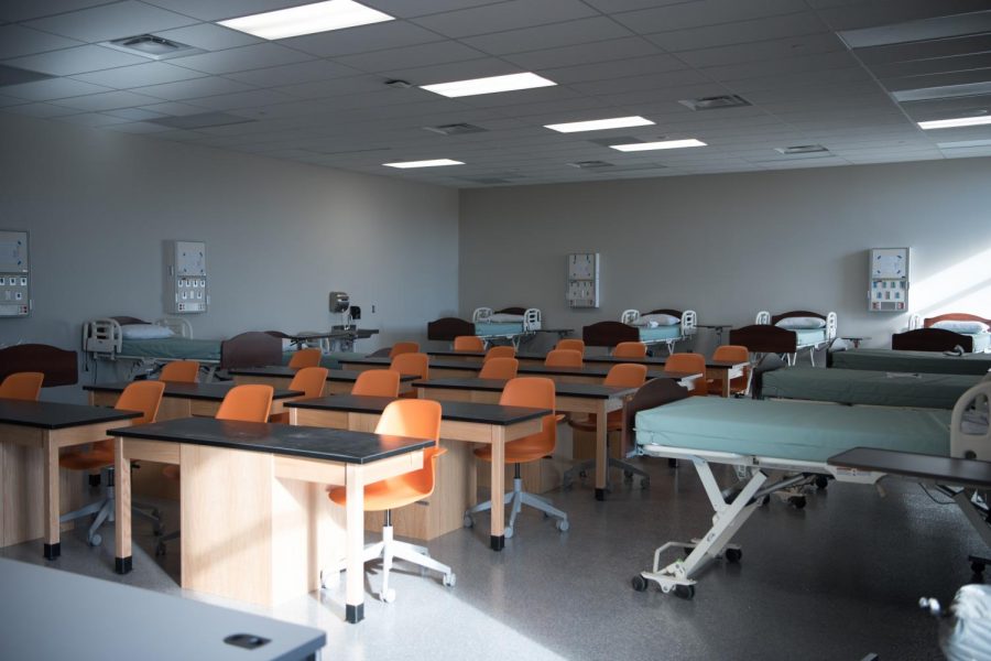 The new CNA room with desks and mock hospital beds. This new room and curriculum will help students become more prepared for the nursing field and beyond. 