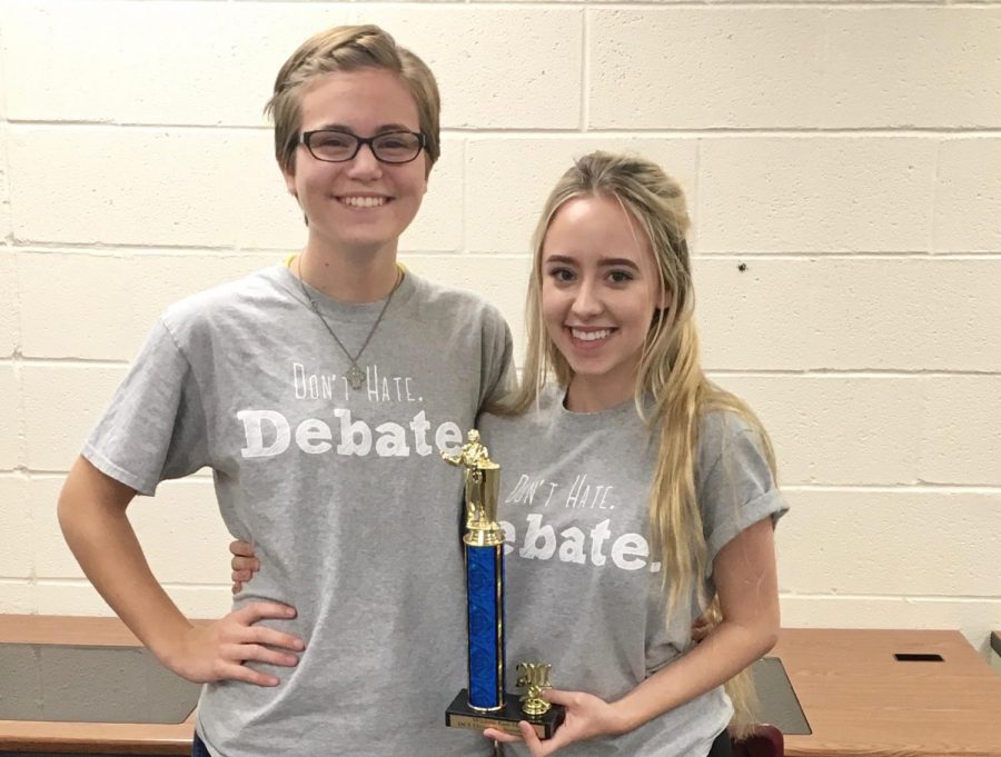 Winners pose with their debate trophy