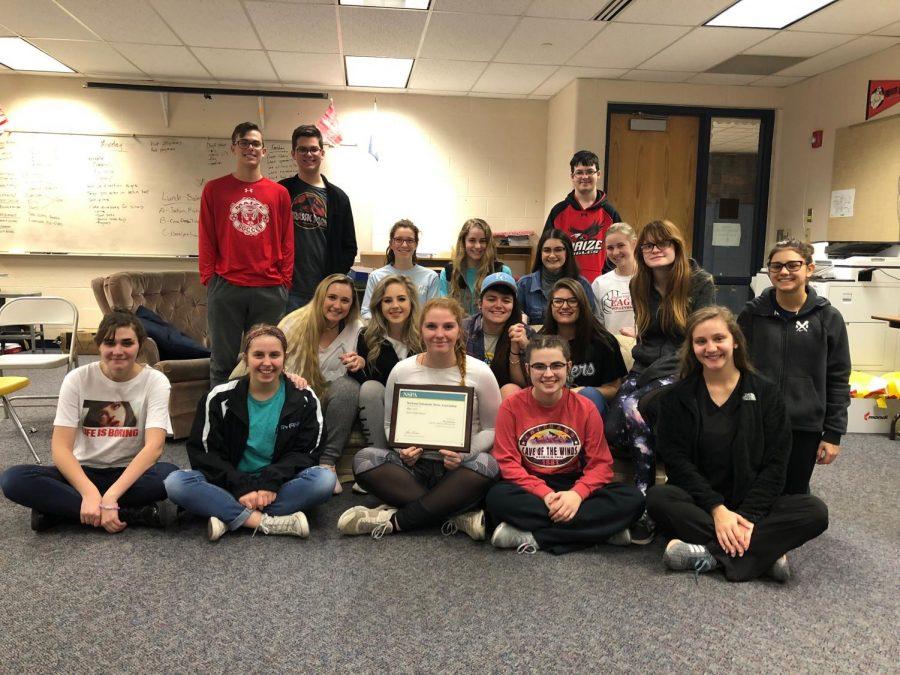 Play staff poses for picture with NSPA plaque. Play earned an All-American with Five Marks of Distinction rating from the NSPA critiques for the 2016-2017 academic year. 
