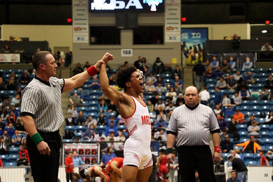 Senior Devin Onwugbufor yells in victory after gaining his first state title. Onwugbufor has wrestled for most of his life.