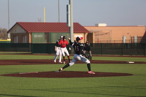 Sophomore Mason Reed pitches in the game against Blue Valley West. The Eagles defeated Kapaun 7-6 and fell to Blue Valley West 10-6.
